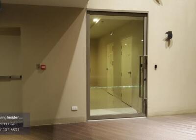 Entrance to a residential building with hallway doors and an emergency exit