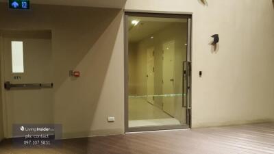 Entrance to a residential building with hallway doors and an emergency exit