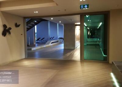 Lobby area with view of a modern indoor pool