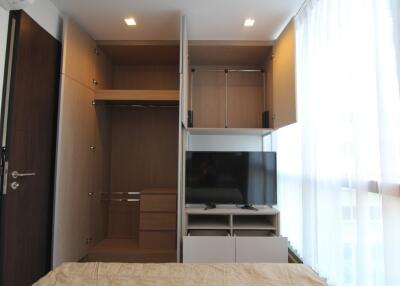 Compact bedroom with built-in wardrobe and mounted TV