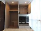 Compact bedroom with built-in wardrobe and mounted TV