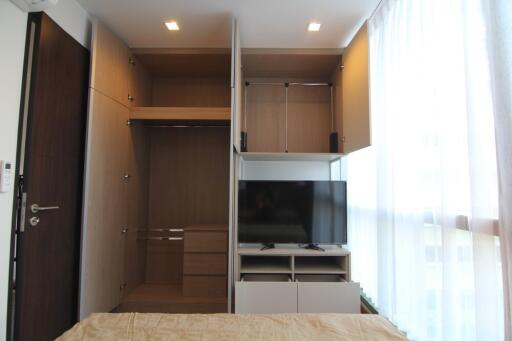 Compact bedroom with built-in wardrobe and mounted TV