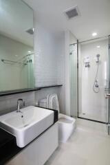 Modern bathroom with glass shower and large mirror