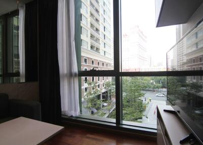 Living room with large windows offering a city view