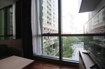 Living room with large windows offering a city view