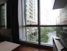 Living room with large windows offering a city view