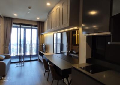 Modern living area with open kitchen and balcony view