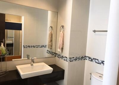 Modern bathroom with large mirror and white sink