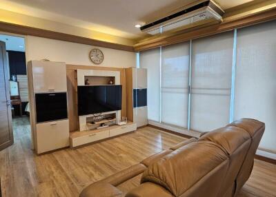 Spacious living room with wooden flooring and modern amenities