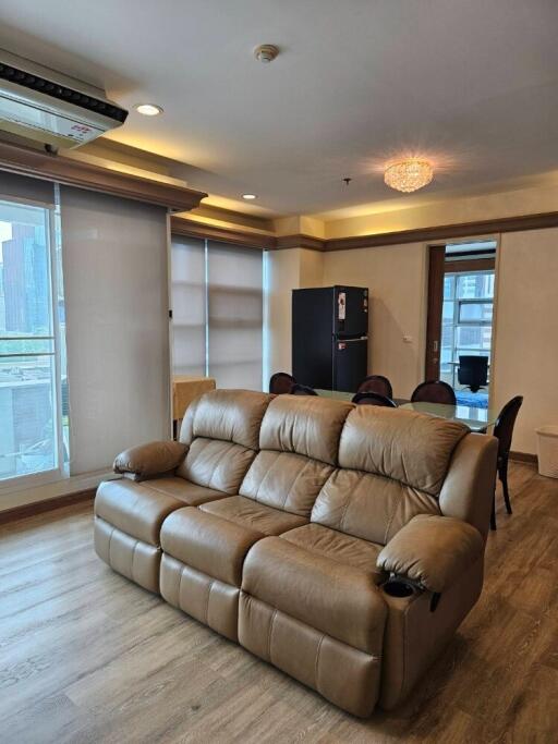 Spacious living room with leather sofa and dining area