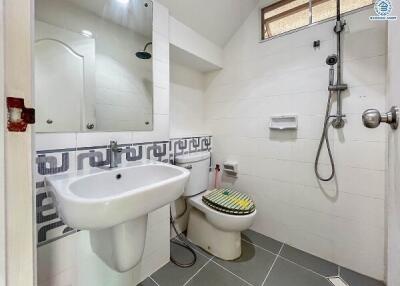 Modern bathroom with white tiles and a pedestal sink