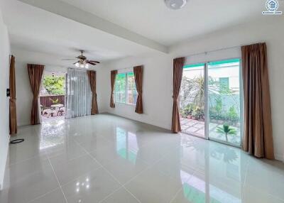 Spacious living room with large windows and sliding glass door