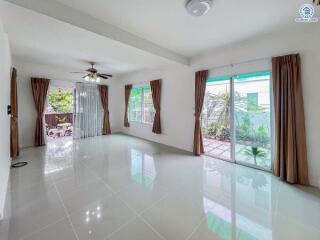 Spacious living room with large windows and sliding glass door