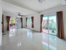 Spacious living room with large windows and sliding glass door