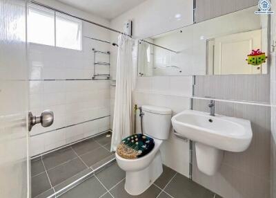 Modern bathroom with walk-in shower, sink, and toilet