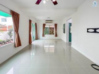 spacious living room with large windows and tiled floor