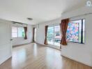 Bright living room with large windows and wooden flooring