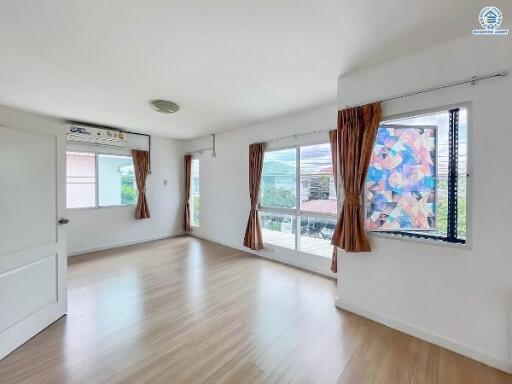 Bright living room with large windows and wooden flooring