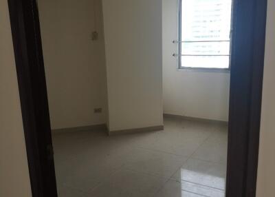 Empty bedroom with a window and air conditioning unit