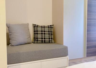 Cozy bedroom corner with a sitting area and pillows