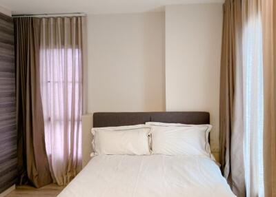 Bedroom with double bed, curtains, and ambient lighting