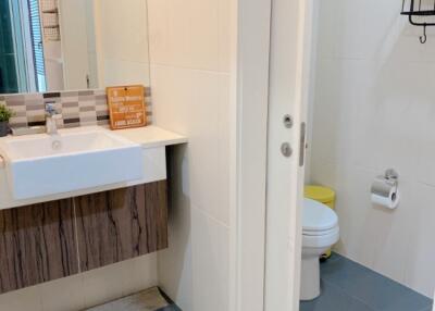 Modern bathroom with sink, toilet, and shower