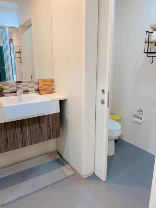 Modern bathroom with sink, toilet, and shower