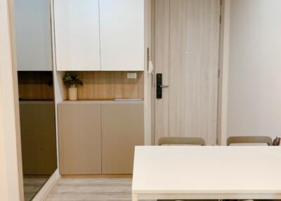 Small dining area with a table and four chairs, cabinet, and a door