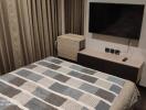 Bedroom with bed and a television