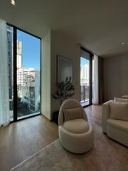 Modern living room with tall windows and city view