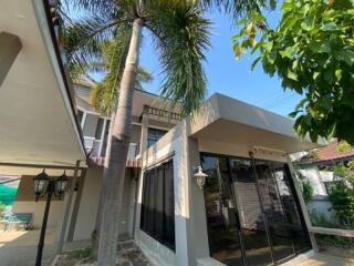 Exterior view of a residential building with palm trees