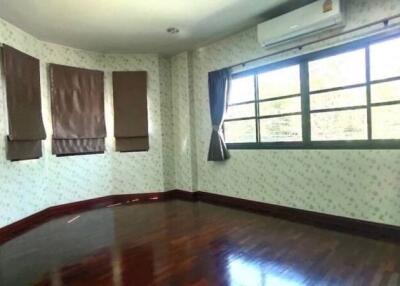 Bedroom with wooden floor and large windows