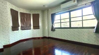 Bedroom with wooden floor and large windows