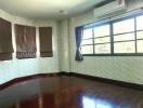 Bedroom with wooden floor and large windows