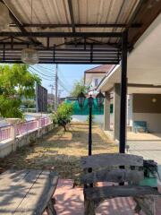 Covered outdoor seating area with garden view