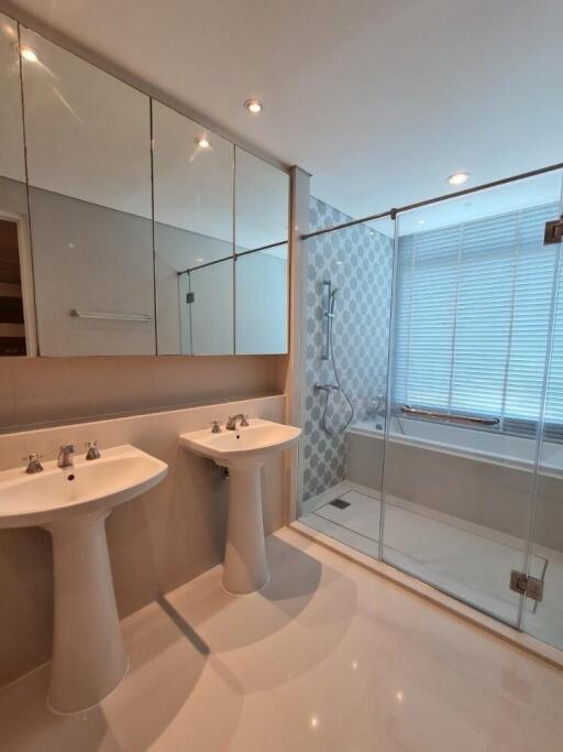 Bathroom with dual sinks and modern shower