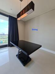 Modern dining area with sleek black table and stylish lighting