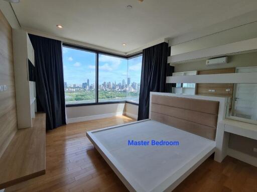 Modern master bedroom with large windows and city view