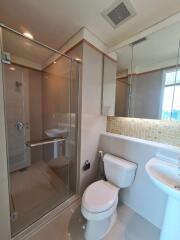 Modern bathroom with glass shower and white fixtures