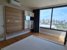 Spacious bedroom with large windows and city view