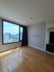 Spacious bedroom with large window and city view