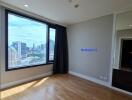 Spacious bedroom with large window and city view