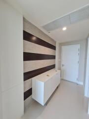 Modern hallway with cabinet storage and wall accents