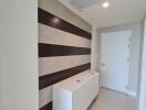 Modern hallway with cabinet storage and wall accents