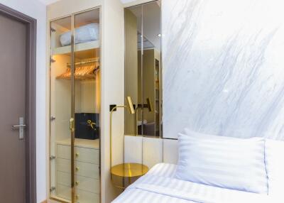 Modern bedroom with built-in wardrobe and marble accent wall