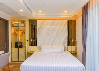 Spacious and modern bedroom with mirrored wardrobe and elegant lighting