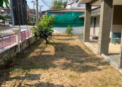 House backyard with lawn and covered porch