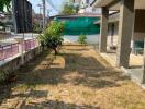 House backyard with lawn and covered porch