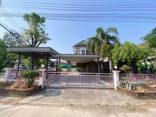 Front view of a residential property with driveway and garden area