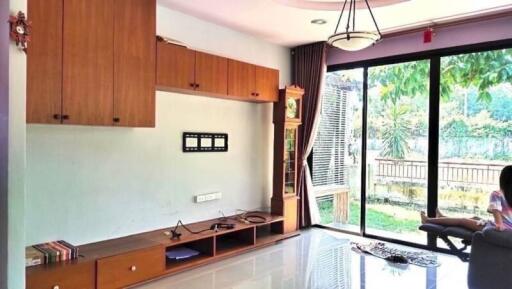 Spacious living room with large window and modern shelving